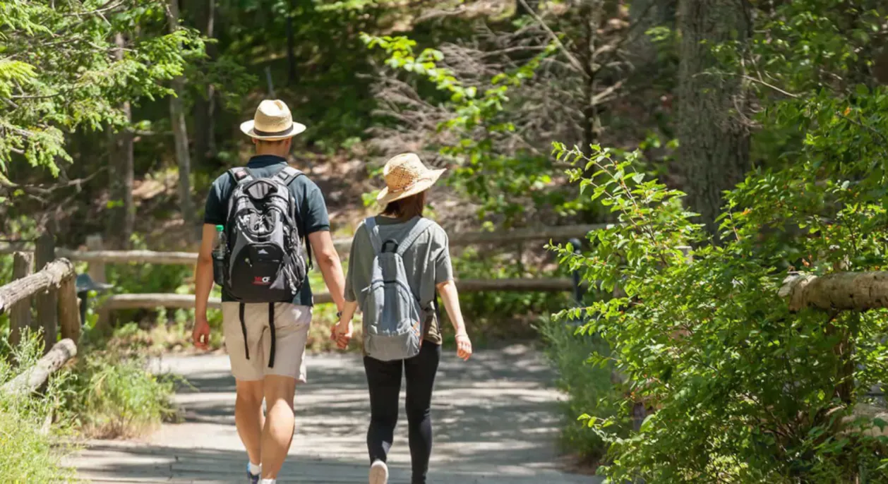 Couple holding hands on hike at Mohonk Mountain House romantic getaway in new york